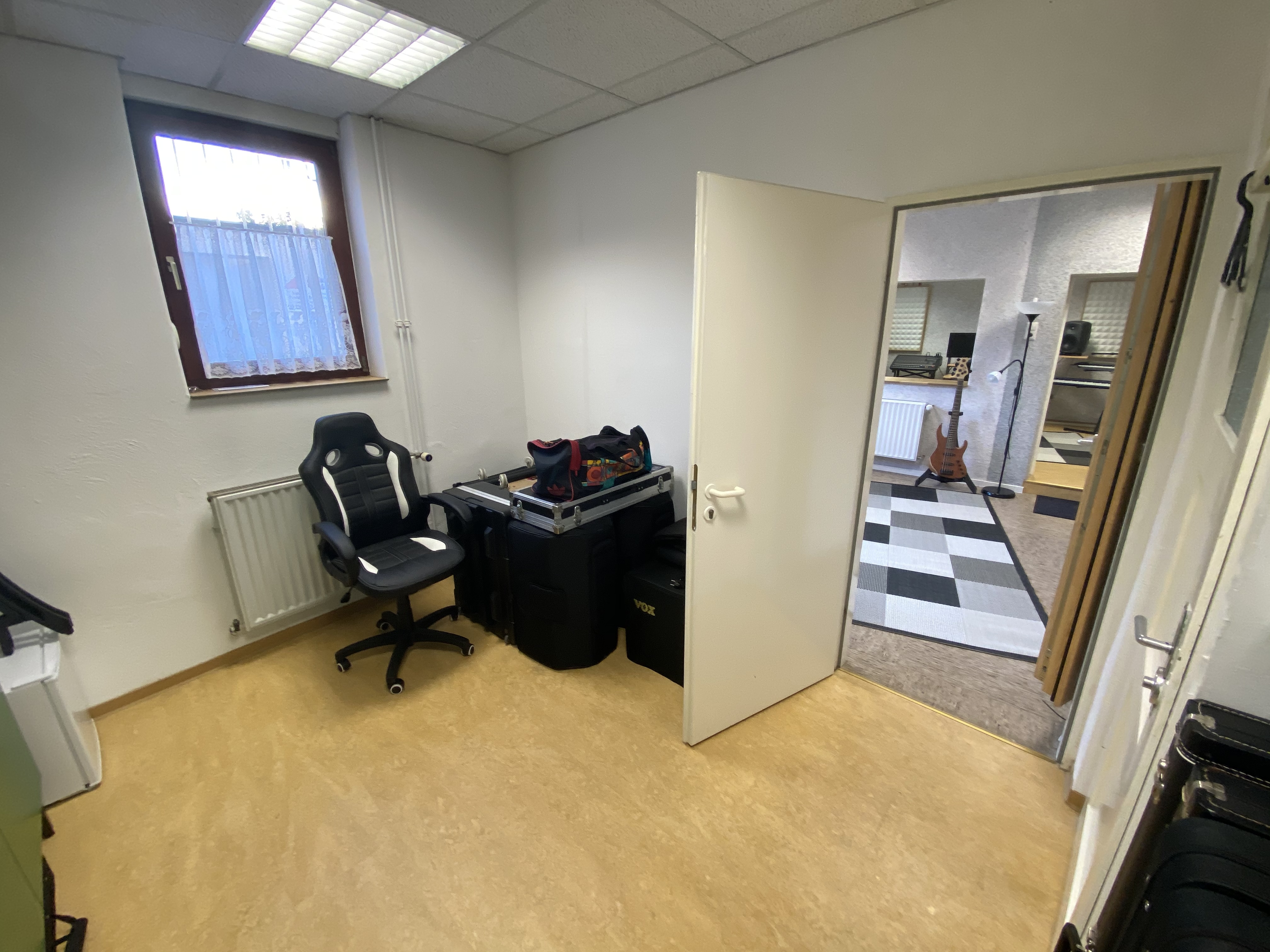 DJ facing a crowd at his deck. Photo with a purple hue